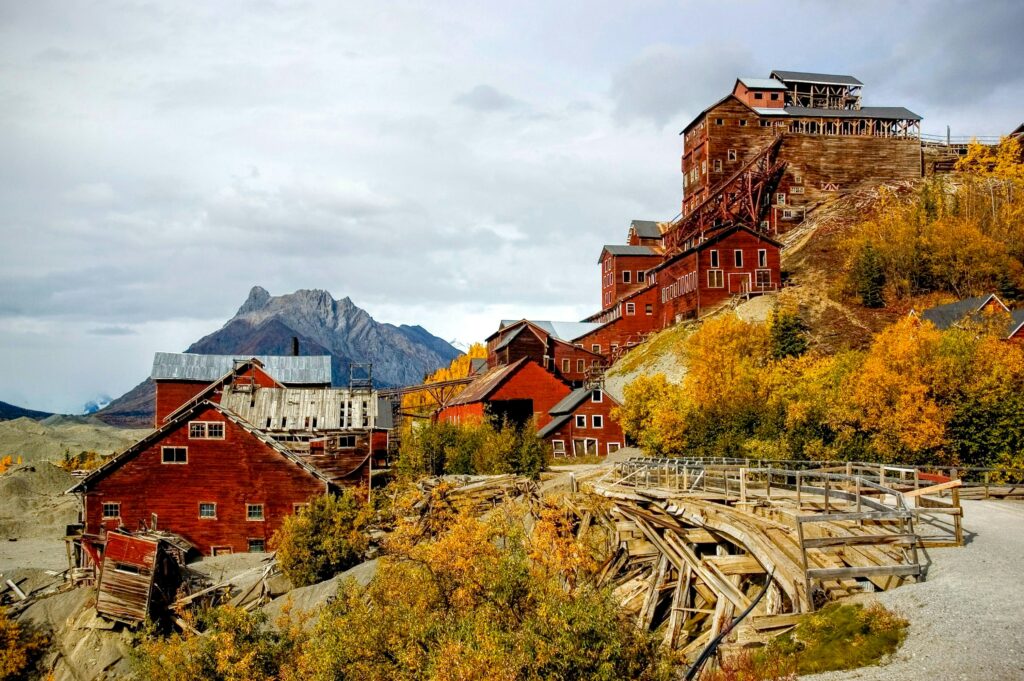 Historic red wooden mill in a mountain landscape in Alaska.