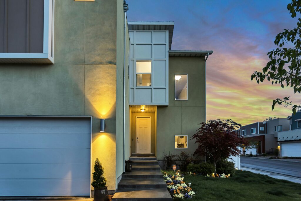 Modern house entrance illuminated at sunset.