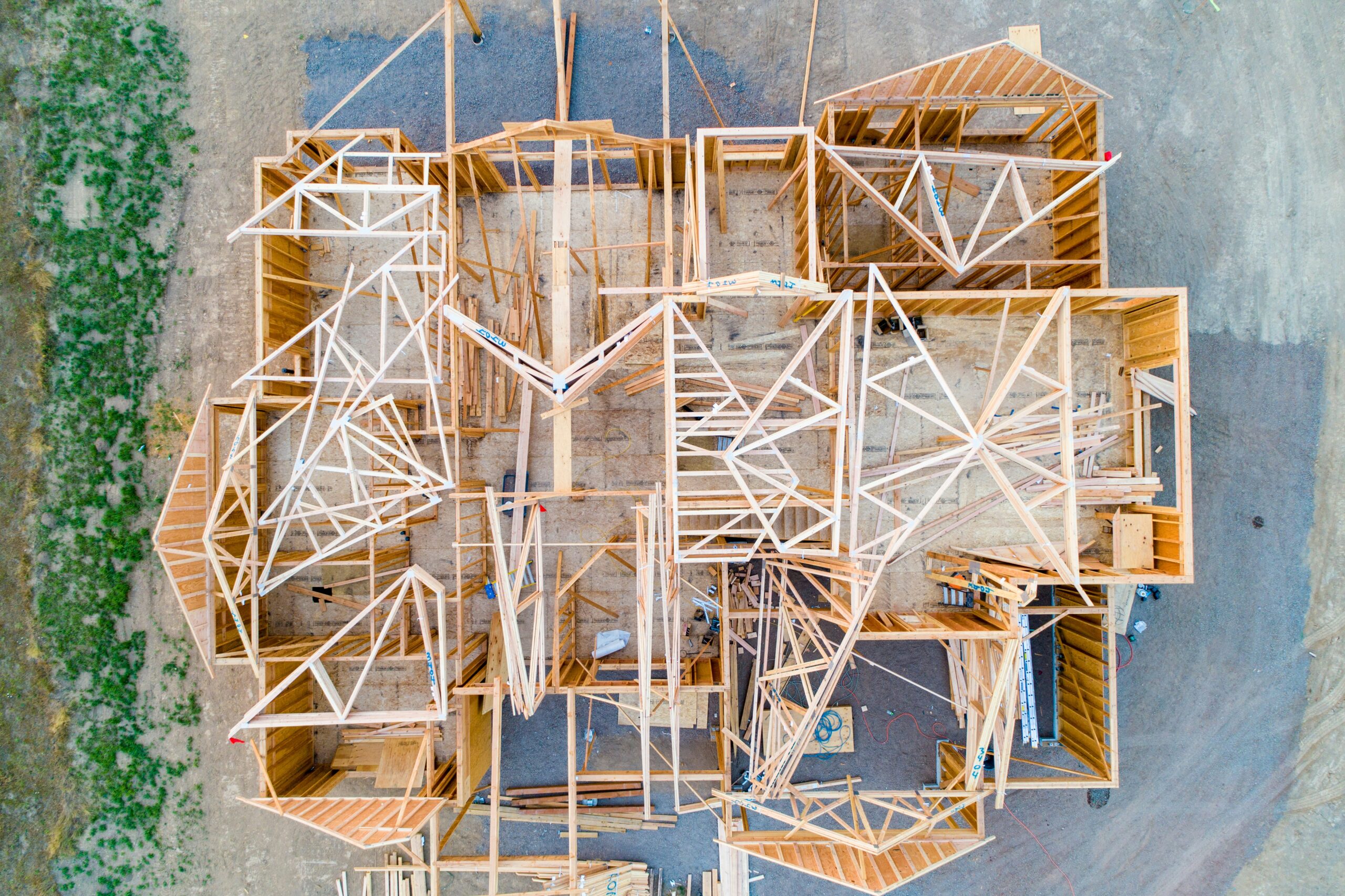Top-down view of a fix and flip renovation project showing roof framing in progress