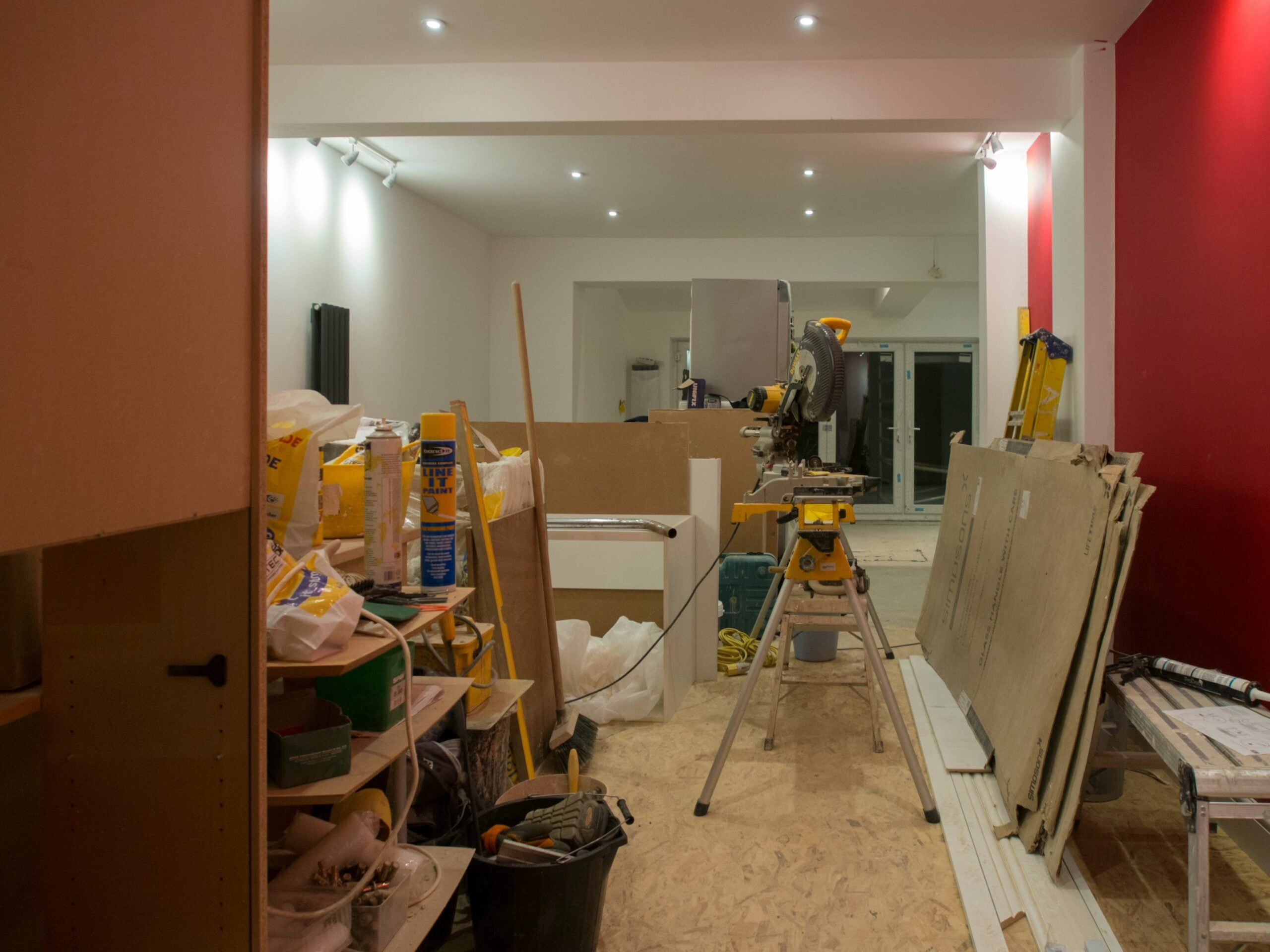 An interior of a house that is newly painted and is currently renovated with the things used in renovation.