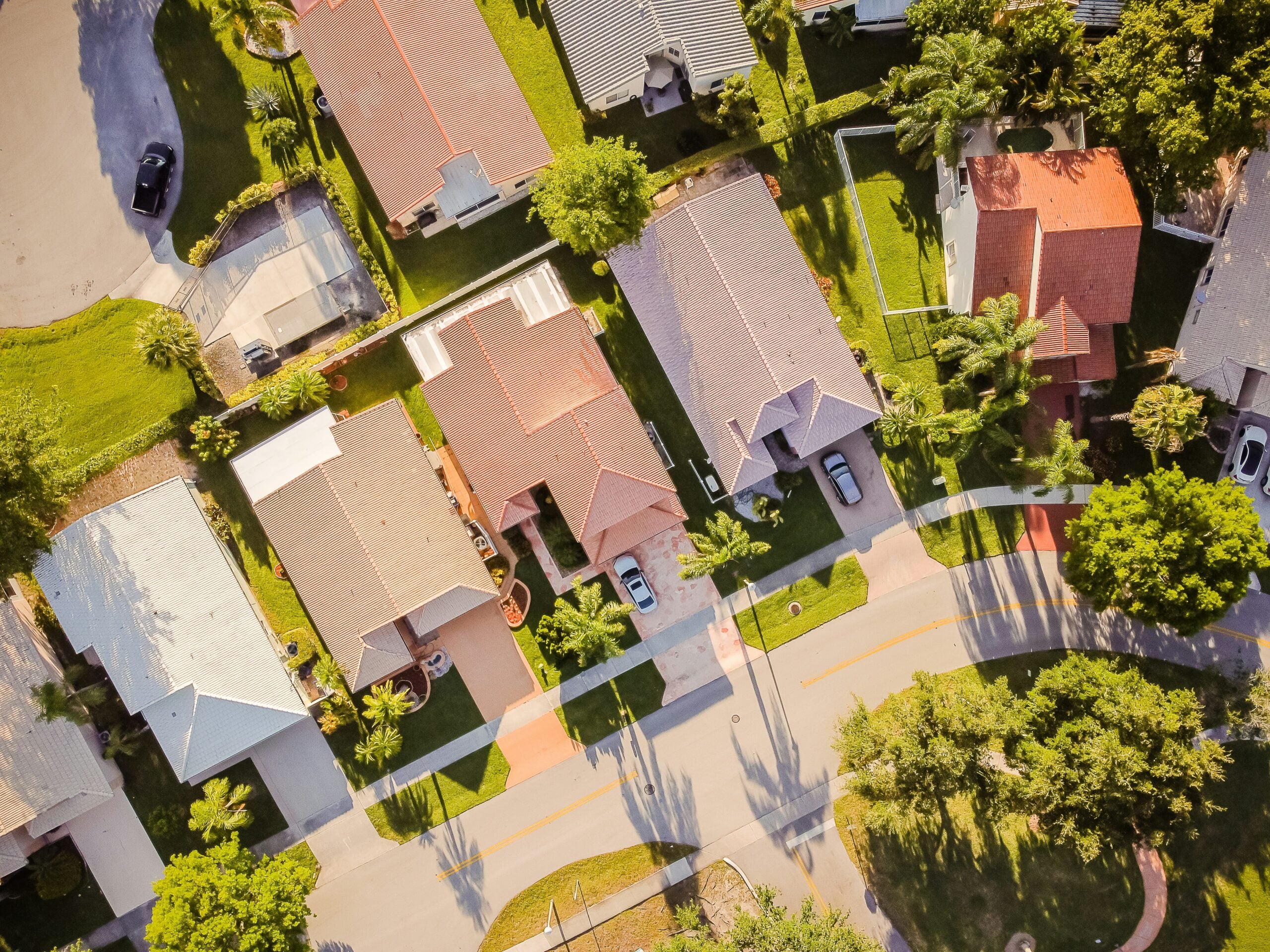 Top view of different houses with trees beside the houses.