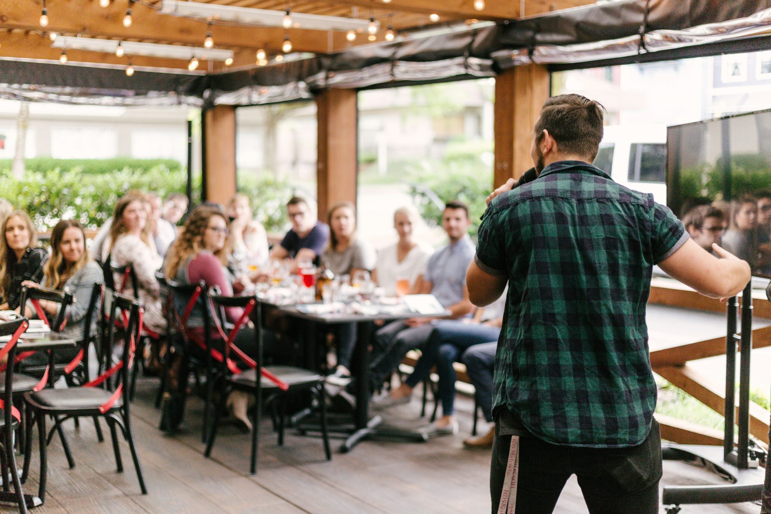 A man speaking in front of people.