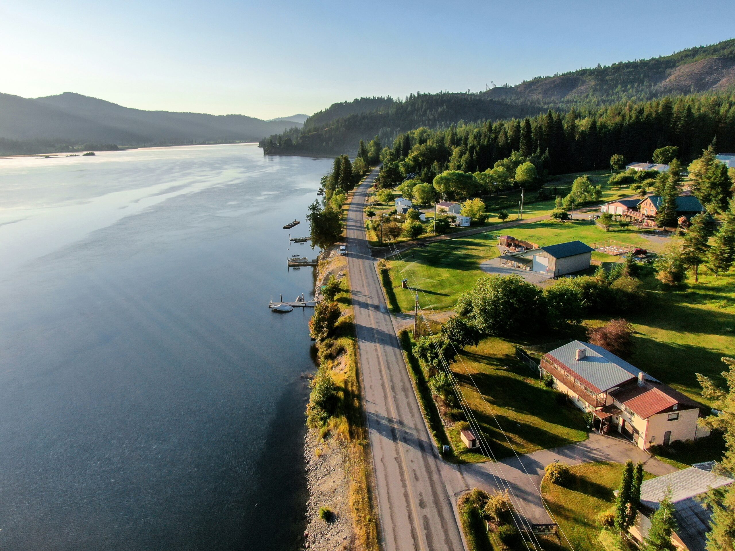 A top view of houses and a road beside Lake Pend Oreille in Idaho.