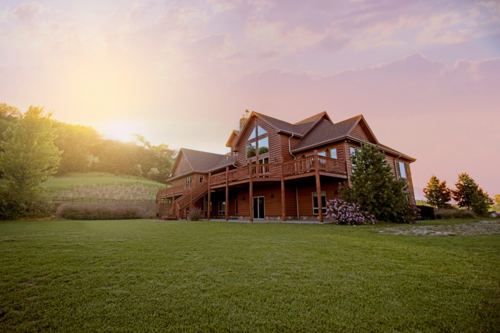 A landscape view of a beautiful house in Iowa with a sunset.